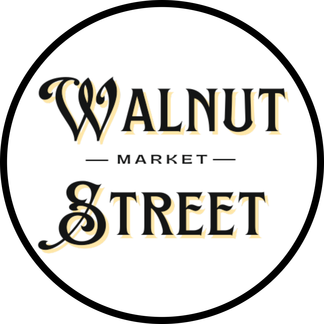 A circular logo with the words 'WALNUT MARKET STREET' in black decorative lettering with a pale gold outline on a white background.